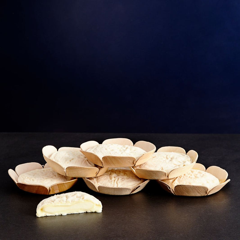 A pile of sir lancelot, with one cut into half with an oozy paste.