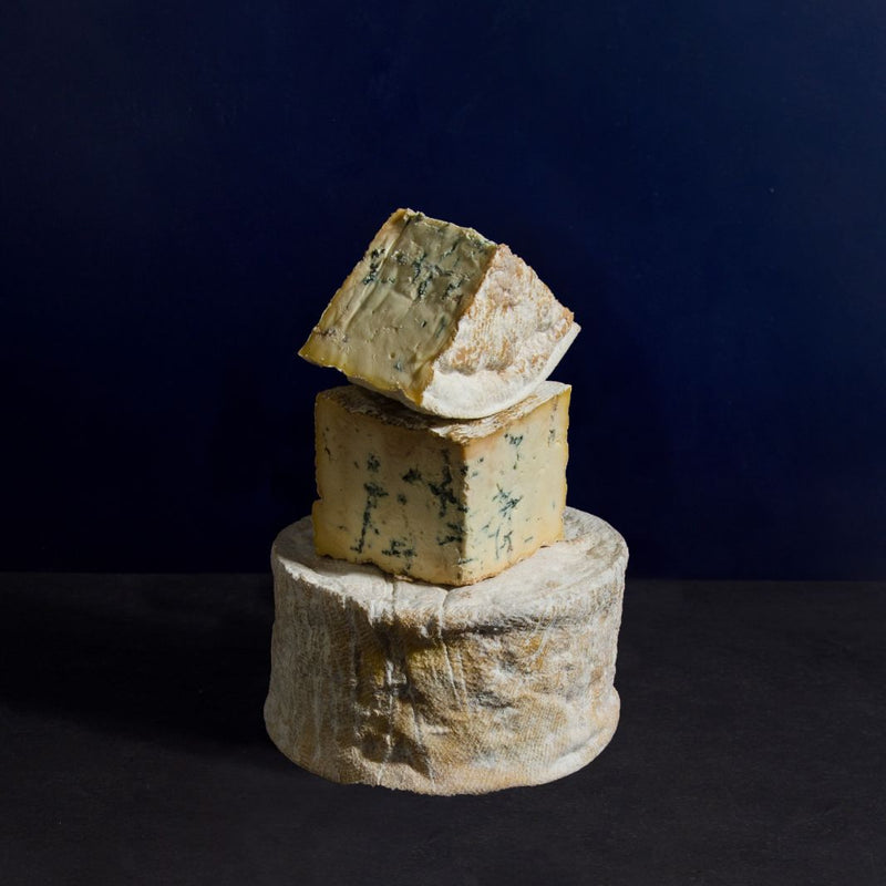 A tower of Pevensey blue cut into different sizes, showing the mottled paste with dark blue veining.