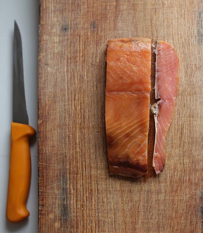 A piece of wild, Irish, traditionally-smoked salmon on a chopping board